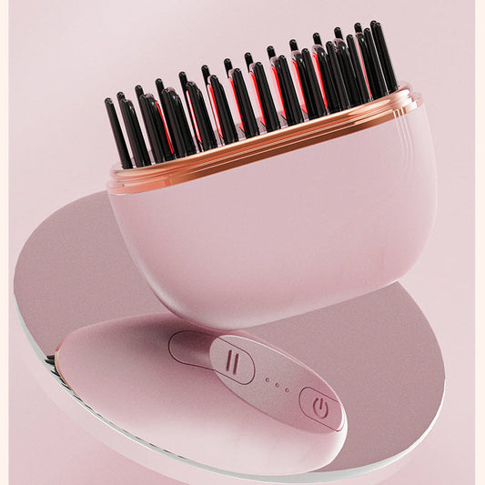 Pink hair care device with black bristle brush head on a light pink background